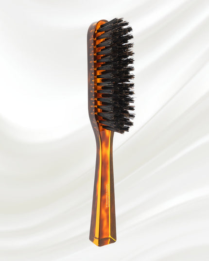 The Koh-I-Noor Rectangular Hair Brush with Natural Bristles is a sleek and sophisticated grooming tool. Hand-crafted in Italy, it features five rows of firm natural bristles that will condition your hair and stimulate your scalp. Part of the Jaspè collection, its faux tortoise handle is designed for comfort. Hand-crafted with the finest materials in Italy.