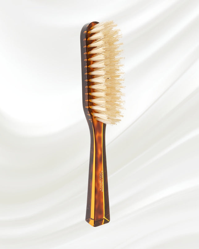 The Koh-I-Noor Rectangular Hair Brush with Natural Bristles is a sleek and sophisticated grooming tool. Hand-crafted in Italy, it features five rows of firm natural bristles that will condition your hair and stimulate your scalp. Part of the Jaspè collection, its faux tortoise handle is designed for comfort. Hand-crafted with the finest materials in Italy.