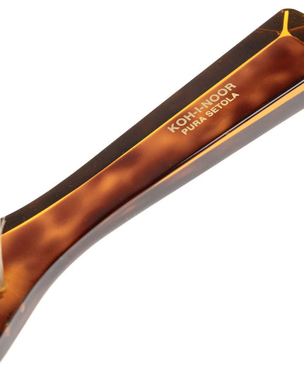 The Koh-I-Noor Rectangular Hair Brush with Natural Bristles is a sleek and sophisticated grooming tool. Hand-crafted in Italy, it features five rows of firm natural bristles that will condition your hair and stimulate your scalp. Part of the Jaspè collection, its faux tortoise handle is designed for comfort. Hand-crafted with the finest materials in Italy.