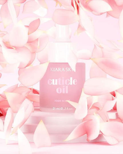 Kiara Sky Rose Scented Cuticle Oil is a professional-grade formula designed to hydrate and condition cuticles during and after salon services. Infused with vitamin E, sweet almond oil, and jojoba oil, this cuticle oil helps replenish moisture lost through chemical or mechanical nail treatments, leaving the nail bed and surrounding skin soft and resilient. Its light rose fragrance provides a clean, refreshing finish without overpowering the service environment. The 0.7 fl oz size is ideal for workstation use