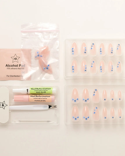 A little bloom goes a long way with Sprigs of Blue. These press-on nails embrace delicate floral accents without overwhelming your style. Soft blue petals scatter over a neutral base, creating a design that’s light, refined, and effortlessly elegant. The medium almond shape keeps things polished, while the glossy finish enhances the fresh, minimalist appeal. Whether you're elevating an everyday look or adding a subtle floral flourish, Sprigs of Blue is proof that simplicity blooms beautifully.