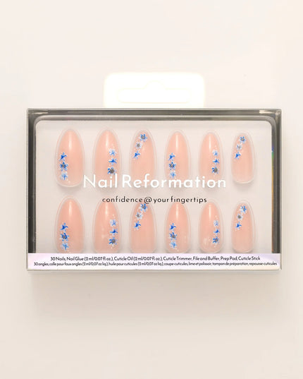 A little bloom goes a long way with Sprigs of Blue. These press-on nails embrace delicate floral accents without overwhelming your style. Soft blue petals scatter over a neutral base, creating a design that’s light, refined, and effortlessly elegant. The medium almond shape keeps things polished, while the glossy finish enhances the fresh, minimalist appeal. Whether you're elevating an everyday look or adding a subtle floral flourish, Sprigs of Blue is proof that simplicity blooms beautifully.