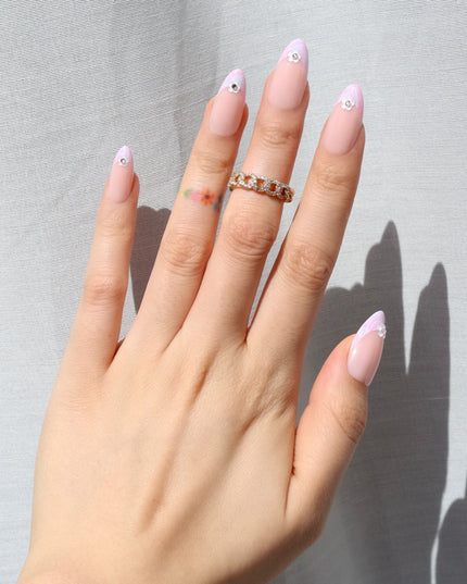 Like daydreams of Paris, Floral Reverie sweeps you away to a world of soft elegance and effortless charm. Blended pastel swirls on classic French tips mimic the watercolor skies over the Seine at dawn, while dainty floral accents add a touch of je ne sais quoi. The medium almond shape offers a refined silhouette, and the glossy finish captures the light like a Parisian café window on a sunny morning.