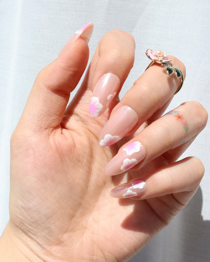 A glow that blooms all season. Sakura Glow press-on nails bring scattered cherry blossom petals with a glossy pink base that catches the light beautifully. The petals alternate across the tip and base, creating a design that feels like a gentle cascade of cherry blossoms in full bloom.