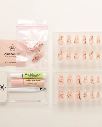 As effortless as cherry blossoms drifting in the wind. Soft Sakura press-ons embrace the beauty of simplicity with delicate floral accents on a soft nude base. Wispy branches stretch across each nail, adorned with hand-painted cherry blossoms and subtle gold flecks for a natural glow.