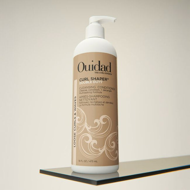 Ouidad's Curl Shaper Double Duty Cleansing Conditioner can be used as a daily conditioner or as a co-wash to cleanse and hydrate hair. This multitasking formula detangles while infusing moisture to encourage definition and add volume without weighing down your curls. When used as a co-wash, the creamy formula gently removes build-up, impurities, and excess oil without stripping your hair. However you choose to use it, rice bran oil and resurrection flower help boost moisture levels to build curl memory.