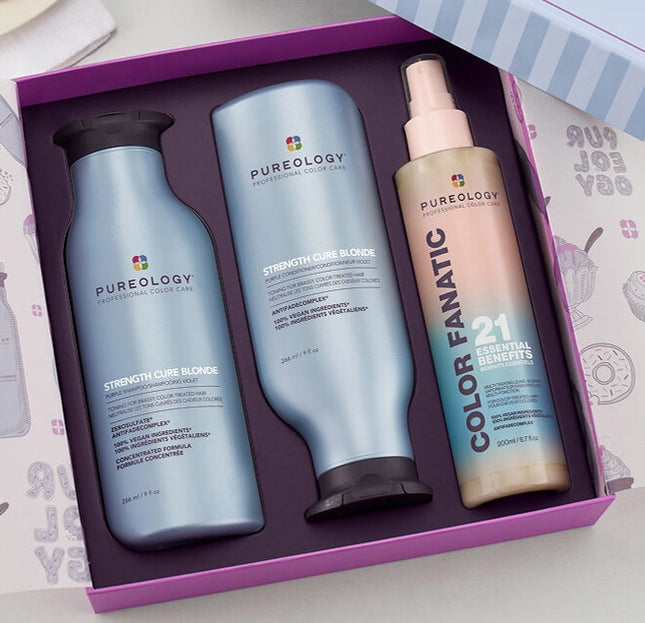 The Pureology Strength Cure Blonde Holiday Kit is a must-have for lightened hair, helping to neutralize brassy tones while repairing damage and preventing future breakage.